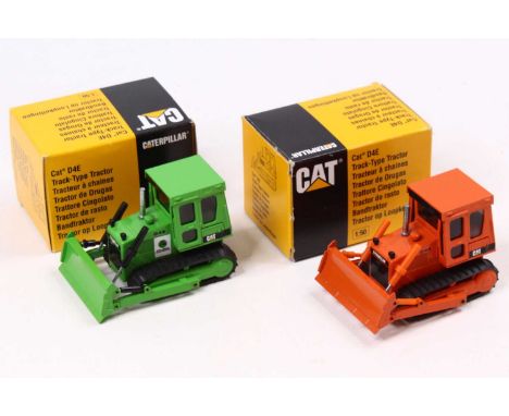 An NZG 2 1/50 scale Caterpillar D4E Track-Type Tractors, the first one being in green body and another in orange. Both housed