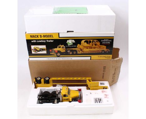 A First Gear 1/25 scale No. 49-0030 Construction Pioneers Mack B Model with a low boy trailer, housed in a polystyrene packed