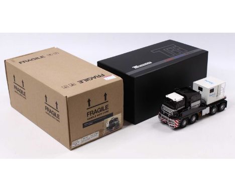 An IMC Models 1/50 scale model of a Nicholas Tractomas Bauma 2016 edition, mostly black body with a white roof, and white sec
