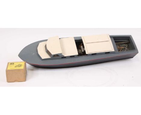 A wooden kit-built model of a cabin cruiser, comprising a black, grey and white body, fitted with an ED Sea Otter MK2 engine,