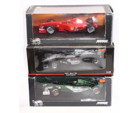 A Minichamps and Hotwheels 1/18 scale group of three boxed F1 Models to include No. 26742 Jaguar R1, by Johnny Herbert, No. 9
