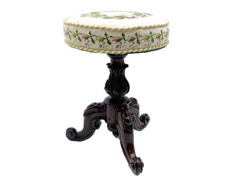 Victorian rosewood rise and fall piano stool, the floral needlework upholstered seat raised on floral and scroll carved tripo