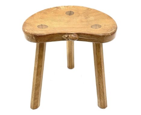 'Mouseman' oak three legged stool with dished kidney shaped seat, tapered octagonal supports, with carved mouse signature, by