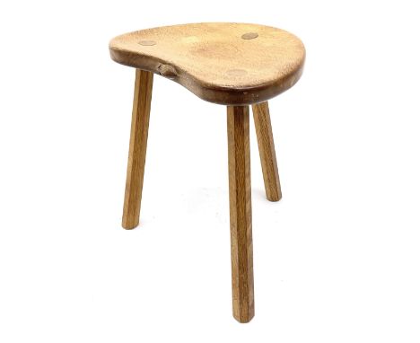 'Mouseman' oak three legged stool with dished kidney shaped seat, tapered octagonal supports, with carved mouse signature, by
