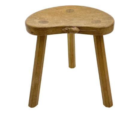 'Mouseman' oak three legged stool with dished kidney shaped seat, tapered octagonal supports, with carved mouse signature, by