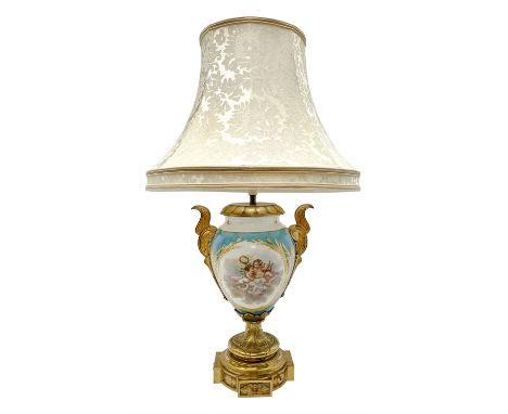 Sevres style table lamp, the ovoid body with twin gilt metal handles, hand painted with a gilt framed panel of cherubs to one