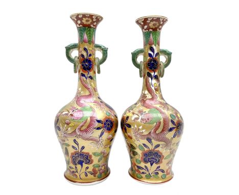 Pair of early 19th century Miles Mason vases, the baluster bodies with tall slender necks supporting twin stylised trunk hand