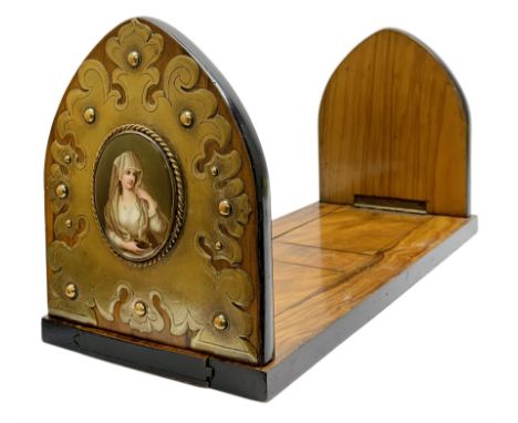 Victorian olive wood book slide, the arched supports with scrolling brass mounts enclosing KPM type porcelain plaques depicti