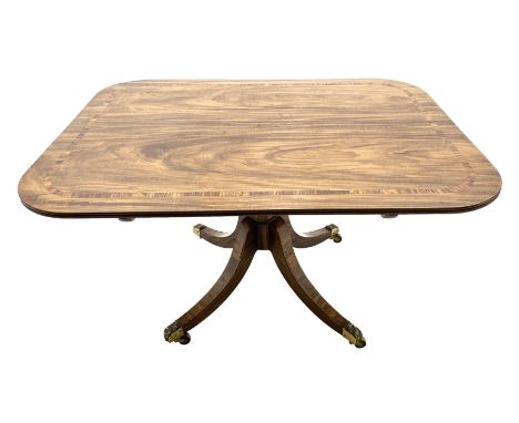 Regency period mahogany breakfast table, the rounded rectangular top with edge mould and rosewood band, on tapered octagonal 