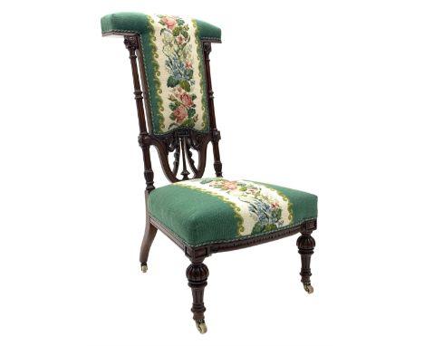 Victorian mahogany prie dieu chair, the carved frame with floral and swag decoration, on fluted and turned supports with bras