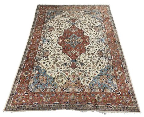 Large Persian carpet, pale ground with peach ground central medallion, the field decorated with interlacing foliate and styli