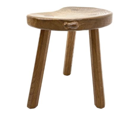 'Mouseman' oak three legged stool with dished kidney shaped seat, tapered octagonal supports, with carved mouse signature, by