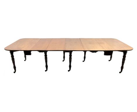 George III mahogany extending dining table, pull out concertina action, raised on eight collar turned supports with brass cup