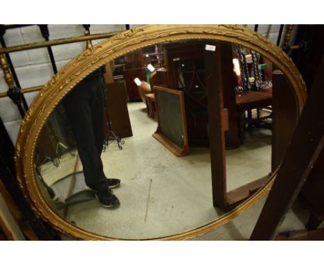 A late 19th or early 20th Century gilt plaster oval wall mirror, approx 110 x 140cm, current fixings to hang in landscape ori