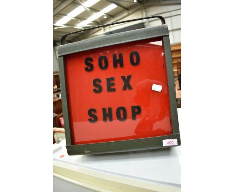 A vintage light , with red and black label for 'soho Sex Shop'