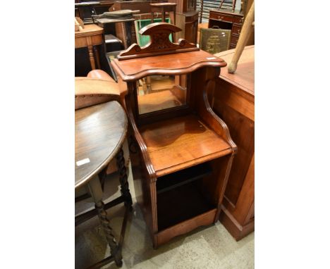 A Victorian mahogany pot cupboard having mirror back and open front, paper label to back for J Rhind, Manchester