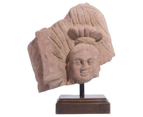 A KUSHAN MOTTLED PINK SANDSTONE RELIEF FRAGMENT, MATHURA, INDIA, 2ND/3RD CENTURY A.D.  carved in relief, probably from a rail
