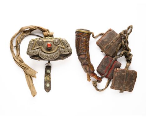 A CARVED POWDER FLASK AND FLINT POUCH, TIBET, 19TH CENTURY  ◉ the flask of carved horn in the form of a makara, with relief d