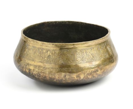 A MAMLUK ENGRAVED BRASS BASIN, EGYPT OR SYRIA, 14TH CENTURY  the sides engraved with a band of calligraphy amidst arabesques,