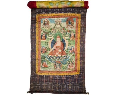 A SINO-TIBETAN THANG-KA DEPICTING A LAMA, 19TH CENTURY pigment with gold on cloth, the large central figure wearing brocaded 