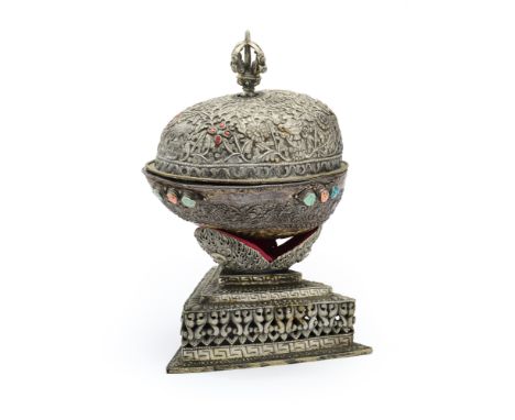 A RITUAL SKULL BOWL (KAPALA), TIBET, 19TH CENTURY  mounted in profusely decorated chased and repousse silver, the underside r