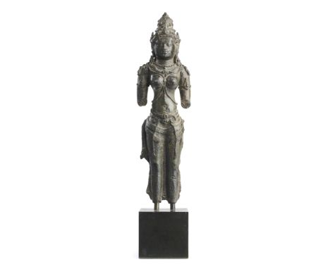 A FRAGMENTARY JAVANESE BRONZE FIGURE OF PARVATI OR BHU-DEVII, INDONESIA, 9TH CENTURY  standing erect, wearing earrings, crown