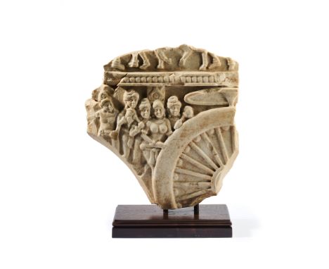 THE ROTATION OF THE WHEEL OF THE LAW, ANDHRA PRADESH, 1ST-2ND CENTURY A.D.  yellow-green limestone carved in relief, a queen 