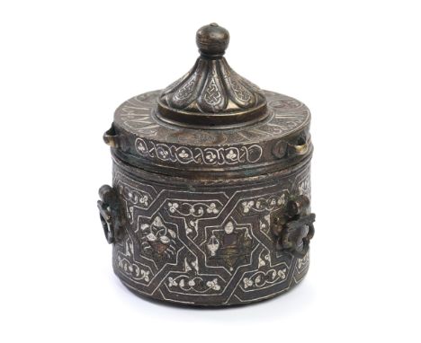 A KHORASAN SILVER INLAID BRONZE INKWELL, CIRCA 13TH CENTURY  of cylindrical form with three hinged suspension loops on the si