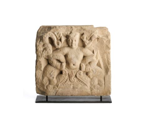 A KUSHAN PANEL DEPICTING A TRITON WITH A PAIR OF MAKARAS, MATHURA, INDIA, 1ST-2ND CENTURY  buff sandstone relief, the figure 