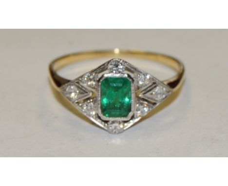 An Art Deco emerald and diamond ring, central rectangular cushion cut vibrant deep green emerald approx 0.60ct, within arched