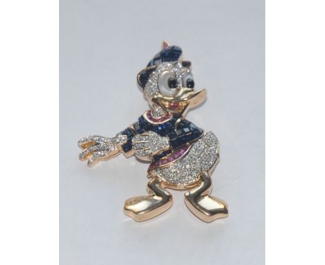 A Walt Disney Inspired Donald Duck diamond ruby and sapphire encrusted brooch, 18ct yellow gold body inset with eighty six br