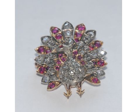 A 19th century diamond, ruby, spinel encrusted peacock brooch, modelled fan tail erect, pave encrusted with forty seven rose 