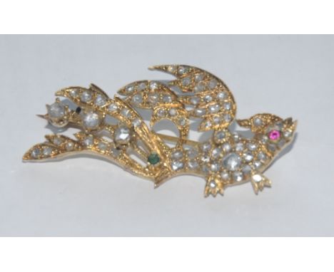 A 19th century diamond ruby and emerald exotic bird brooch, pink ruby eye, emerald accented tail, pave encrusted with approx 