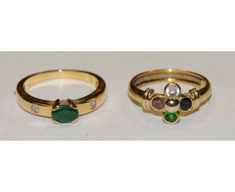 An 18ct gold emerald ring, centrally set oval emerald and two round diamonds set into the shoulders, size O; an 18ct gold dus