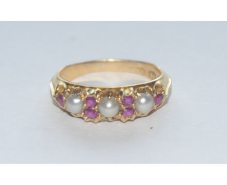 A Victorian ruby and half pearl line ring, the crest inset with six red cushion and round cut rubies and three half pearls, 1