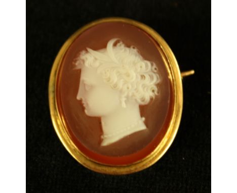 A late 19th century carved agate cameo portrait brooch, neoclassical maiden facing right, floral adorned hair, yellow metal f