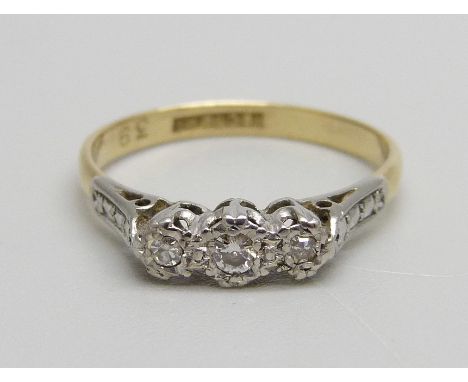 An 18ct gold, platinum set three stone diamond ring, 2.3g, O 