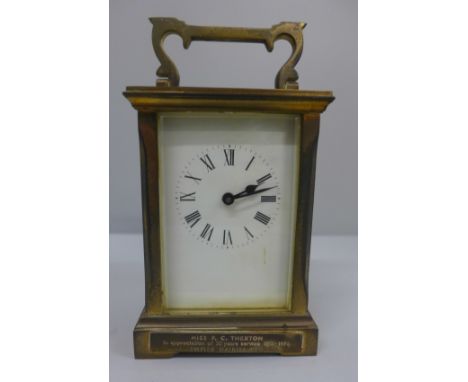 A gilt brass and four glass sided carriage clock with long service inscription plaque to the front 