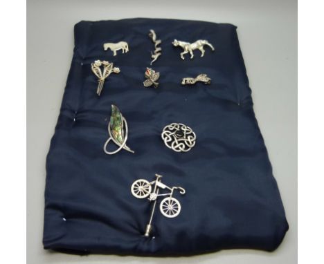 A collection of silver brooches, a silver stick pin, and a Napier horse brooch 