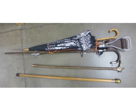 A silver banded walking cane, a Harrods umbrella, walking stick with compass top, a shooting stick and one other walking stic