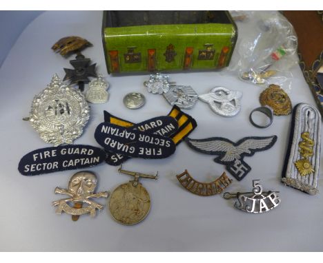 A Macfarlane Lang &amp; Co biscuit tin in the form of a White Star Line cabin trunk with a collection of military badges, var