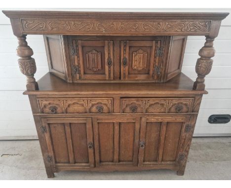 A vintage medium oak Old Charm court cupboard with Gothic style metal drop down handles &amp; hinges. Triple cupboard base wi