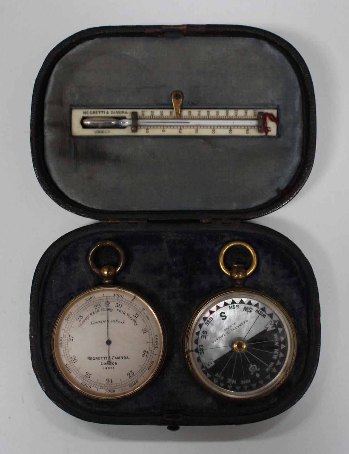 A late 19th century gilt brass pocket barometer, matching compass and