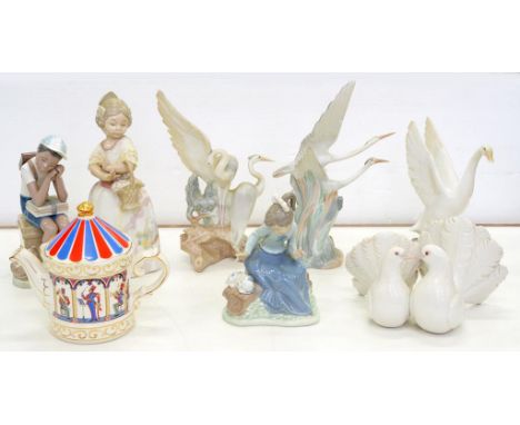 A LLADRO FIGURE OF A SCHOOLBOY, 20.5CM H, PRINTED MARK, A GROUP OF LLADRO DOVES, TWO NAO FIGURES OF GIRLS, THREE NAO BIRDS AN