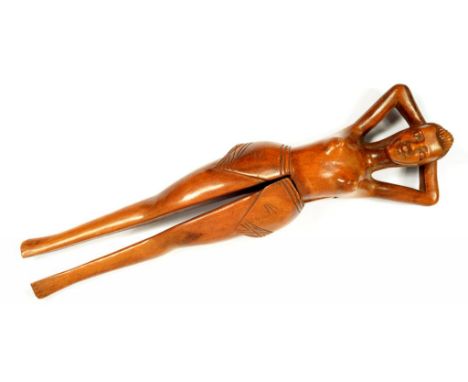 A CARVED WOOD NUT CRACKER, IN THE FORM OF A RECLINING SEMI NAKED WOMAN, 33CM L, EARLY 20TH C