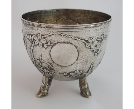 A Chinese silver sugar bowl cast with blossoming branches divided by a plain disc and on branch feet, stamped Yok Sang, 9cm h