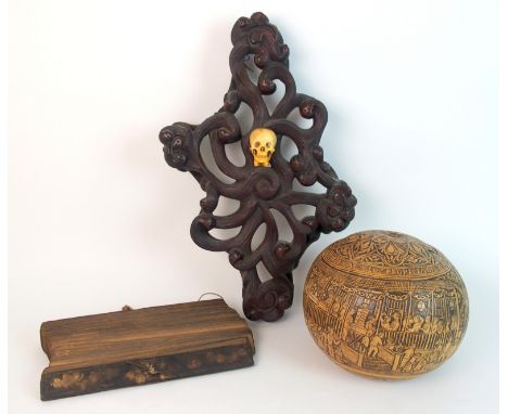 A large carved gourd decorated allover with busy street scenes beneath Spanish script, 19cm high, a hardwood foliate scroll s