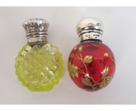 A silver topped scent bottle maker's marks D. F. D. Birmingham 1897, the bulbous cranberry glass body with gilt foliate ename