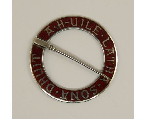 An Enamelled Alexander Ritchie brooch the circular form engraved with the words 'A. H-uile. Latha. Sona. Dhuit' May All Your 