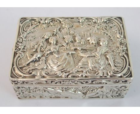 A continental silver trinket box maker's mark B.M. of rectangular shape, the hinged cover embossed with figures playing instr